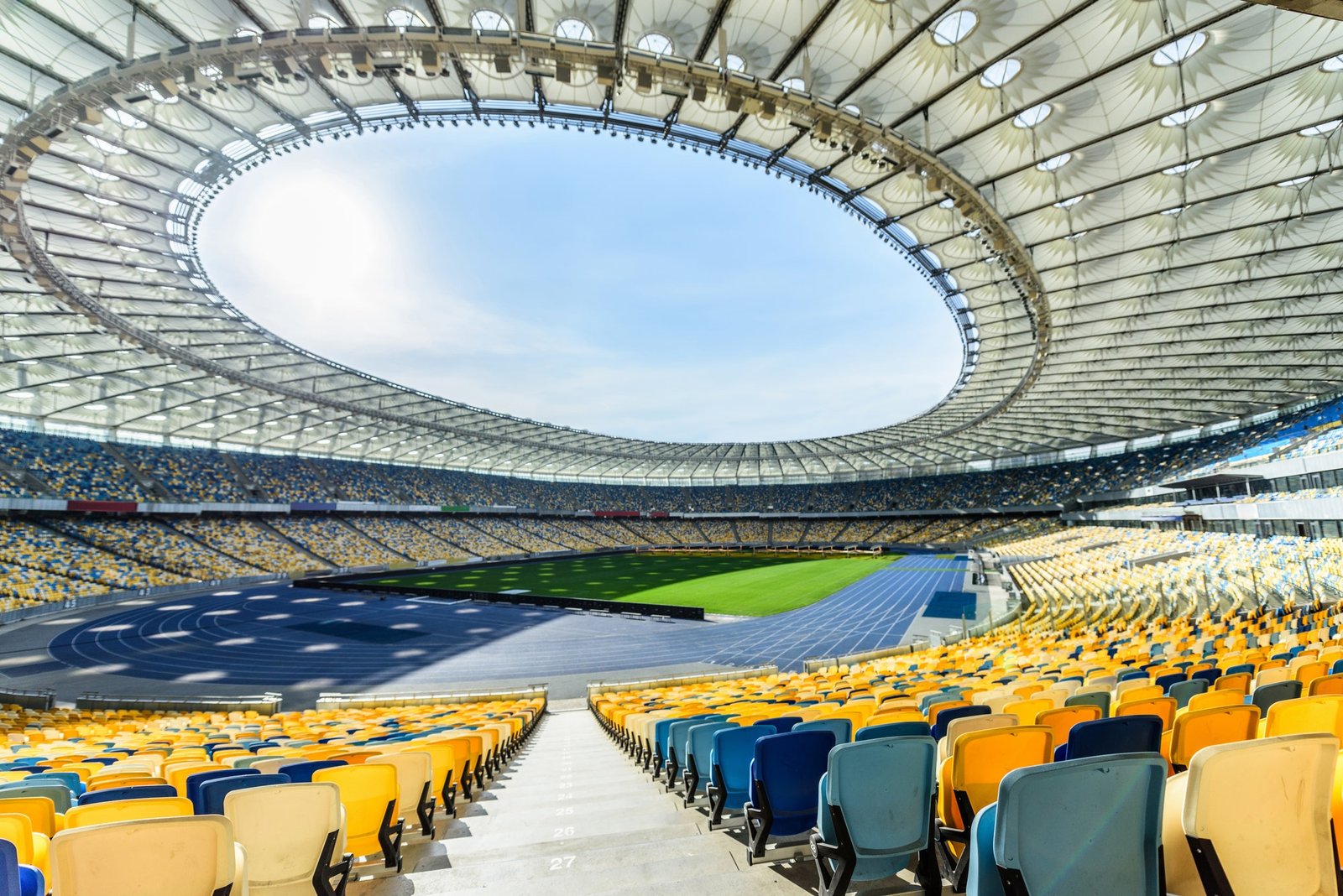 rows-of-yellow-and-blue-stadium-seats-on-soccer-field-stadium.jpg